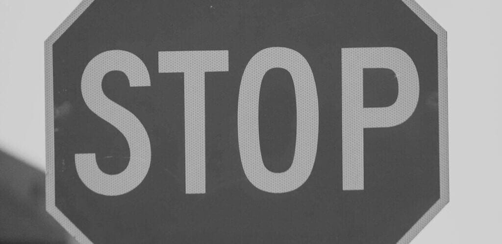 A stop sign close up, symbolizing what cyber insurance doesn't cover.